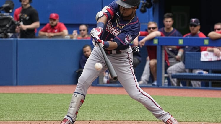 Jun 5, 2022; Toronto, Ontario, CAN; Minnesota Twins designated hitter Luis Arraez (2) hits a single against the Toronto Blue Jays during the second inning at Rogers Centre. Mandatory Credit: John E. Sokolowski-USA TODAY Sports
