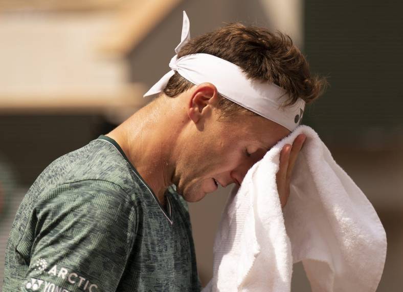 June 5, 2022; Paris, France; Casper Ruud (NOR) takes a towel break during the men s singles final against Rafael Nadal (ESP) on day 15 of the French Open at Stade Roland-Garros. Mandatory Credit: Susan Mullane-USA TODAY Sports