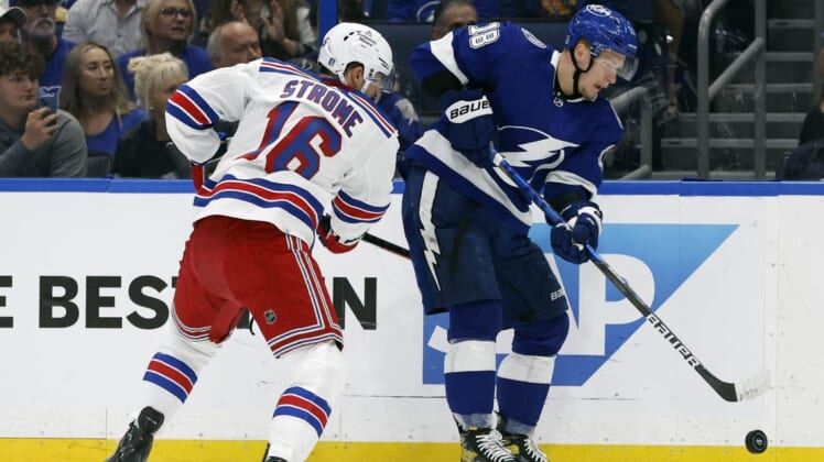 Jun 5, 2022; Tampa, Florida, USA; Tampa Bay Lightning left wing Ondrej Palat (18) passes the puck as New York Rangers center Ryan Strome (16) defends during the first period of the Eastern Conference Final of the 2022 Stanley Cup Playoffs at Amalie Arena. Mandatory Credit: Kim Klement-USA TODAY Sports