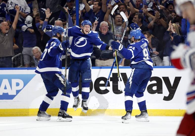 Jun 5, 2022; Tampa, Florida, USA; Tampa Bay Lightning left wing Ondrej Palat (18) celebrates with defenseman Victor Hedman (77) and center Steven Stamkos (91) after scoring a goal against the New York Rangers during the third period of the Eastern Conference Final of the 2022 Stanley Cup Playoffs at Amalie Arena. Mandatory Credit: Kim Klement-USA TODAY Sports