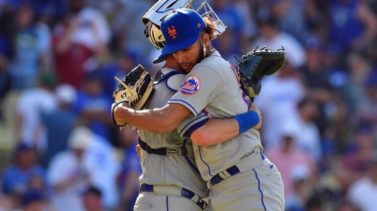 Jun 5, 2022; Los Angeles, California, USA; New York Mets relief pitcher Adonis Medina (68) celebrates the victory with catcher Tomas Nido (3) against the Los Angeles Dodgers at Dodger Stadium. Mandatory Credit: Gary A. Vasquez-USA TODAY Sports