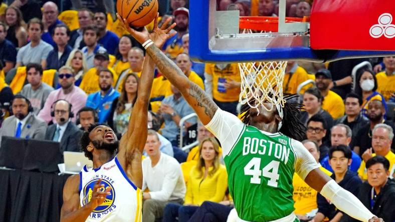 Jun 5, 2022; San Francisco, California, USA; Golden State Warriors forward Andrew Wiggins (22) and Boston Celtics center Robert Williams III (44) go for a rebound during game two of the 2022 NBA Finals at Chase Center. Mandatory Credit: Kyle Terada-USA TODAY Sports