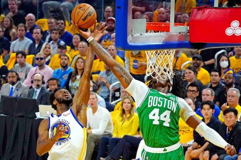 Jun 5, 2022; San Francisco, California, USA; Golden State Warriors forward Andrew Wiggins (22) and Boston Celtics center Robert Williams III (44) go for a rebound during game two of the 2022 NBA Finals at Chase Center. Mandatory Credit: Kyle Terada-USA TODAY Sports