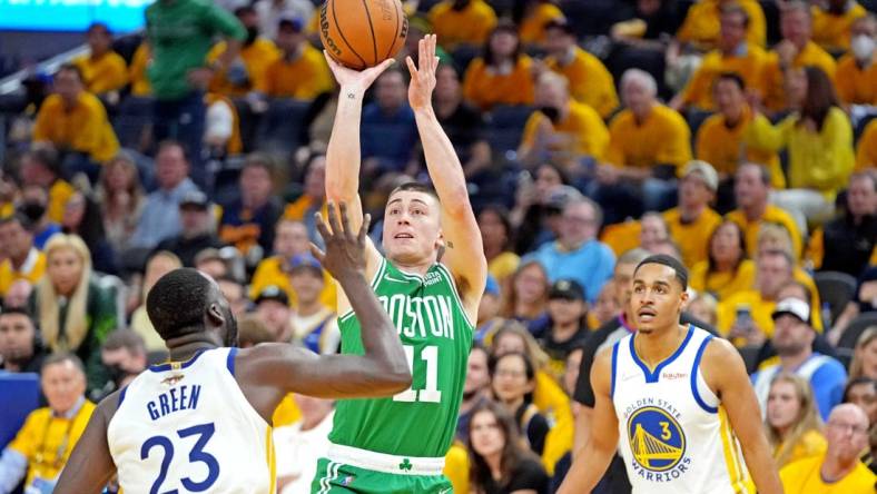 Jun 5, 2022; San Francisco, California, USA; Boston Celtics guard Payton Pritchard (11) shoots the ball against Golden State Warriors forward Draymond Green (23) during game two of the 2022 NBA Finals at Chase Center. Mandatory Credit: Kyle Terada-USA TODAY Sports