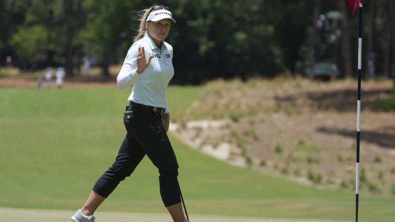 Jun 5, 2022; Southern Pines, North Carolina, USA; Brooke Henderson acknowledges the fans after a putt on the first green during the final round of the U.S. Women's Open. Mandatory Credit: David Yeazell-USA TODAY Sports