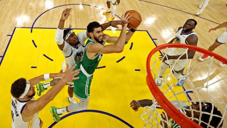 Jun 5, 2022; San Francisco, California, USA; Boston Celtics forward Jayson Tatum (0) shoots the ball against Golden State Warriors center Kevon Looney (5) during game two of the 2022 NBA Finals at Chase Center. Mandatory Credit: Jed Jacobsohn/pool photo-USA TODAY Sports