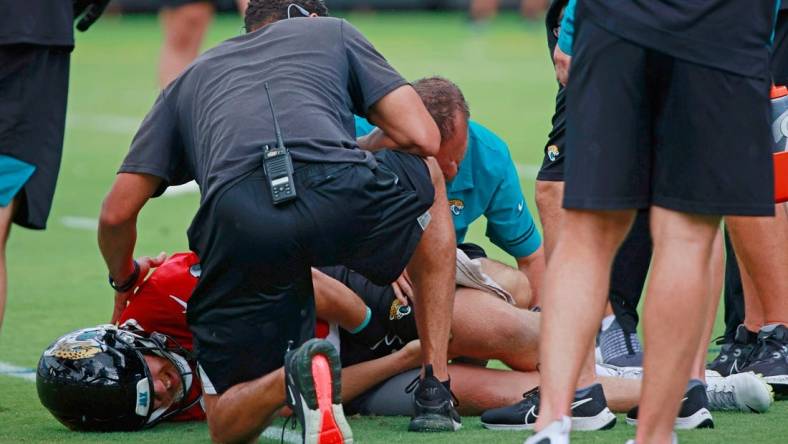 Jacksonville Jaguars quarterback C.J. Beathard (3) is looked at by trainers and personnel while participating in an organized team activity Monday, June 6, 2022 at TIAA Bank Field in Jacksonville.

Jki Ota7 59