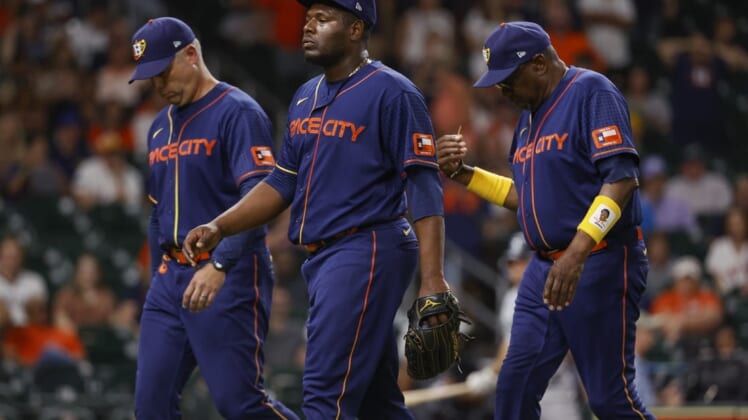 Jun 6, 2022; Houston, Texas, USA; Houston Astros relief pitcher Hector Neris (50) and manager Dusty Baker Jr. (12) walk off the field after being ejected during the ninth inning against the Seattle Mariners at Minute Maid Park. Mandatory Credit: Troy Taormina-USA TODAY Sports
