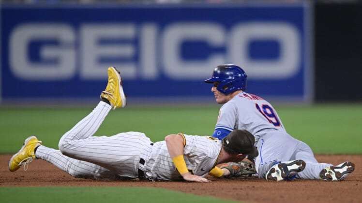Jun 6, 2022; San Diego, California, USA; New York Mets left fielder Mark Canha (19) dives into second base ahead of the tag by San Diego Padres second baseman Jake Cronenworth (left) after hitting a double during the fifth inning at Petco Park. Mandatory Credit: Orlando Ramirez-USA TODAY Sports