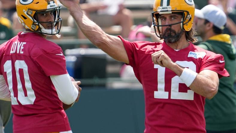 Aaron Rodgers (12) makes a throw while Jordan Love (10) looks on during Green Bay Packers minicamp Tuesday, June 7, 2022 in Green Bay, Wis.

Packers08 1