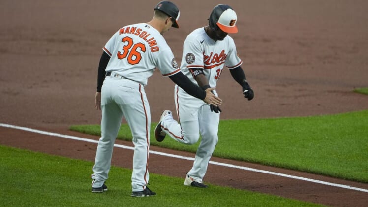 Jun 7, 2022; Baltimore, Maryland, USA; Baltimore Orioles third base coach Tony Mansolino (36) congratulates Baltimore Orioles center fielder Cedric Mullins (31) for hitting a home run as he rounds the bases during the first inning against the Chicago Cubs at Oriole Park at Camden Yards. Mandatory Credit: Gregory Fisher-USA TODAY Sports