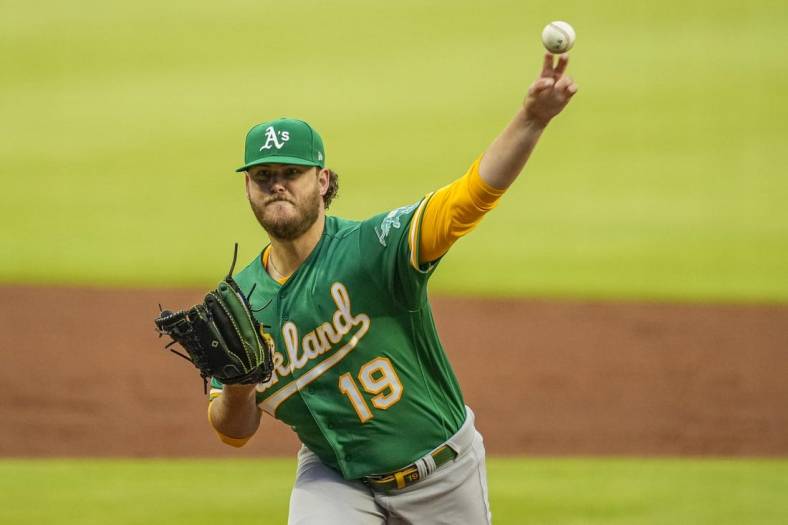 Jun 7, 2022; Cumberland, Georgia, USA; Oakland Athletics starting pitcher Cole Irvin (19) pitches against the Atlanta Braves during the first inning at Truist Park. Mandatory Credit: Dale Zanine-USA TODAY Sports