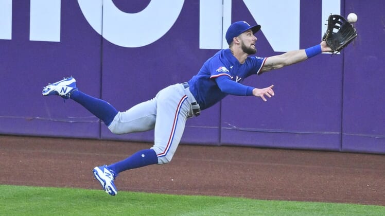Jun 7, 2022; Cleveland, Ohio, USA; Texas Rangers center fielder Eli White (41) makes a diving catch in the first inning against the Cleveland Guardians at Progressive Field. Mandatory Credit: David Richard-USA TODAY Sports