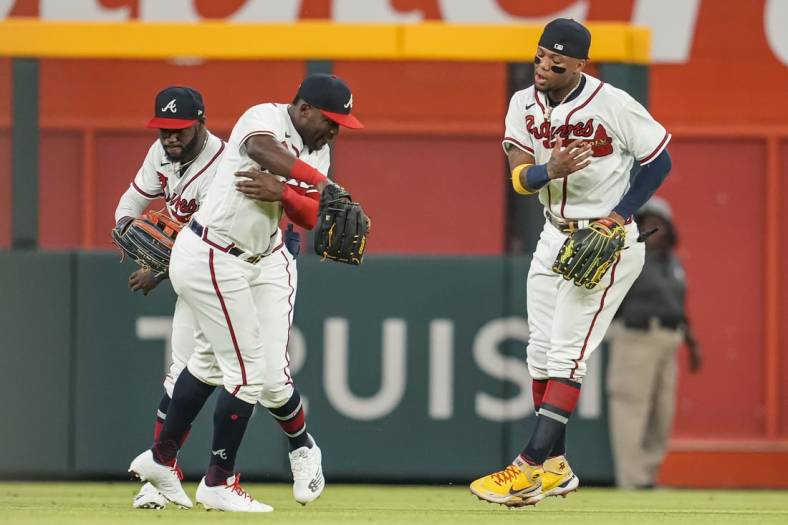 Jun 7, 2022; Cumberland, Georgia, USA; Atlanta Braves outfielders Michael Harris II 
Guillermo Heredia and Ronald Acuna Jr. (left to right) react after defeating the Oakland Athletics at Truist Park. Mandatory Credit: Dale Zanine-USA TODAY Sports