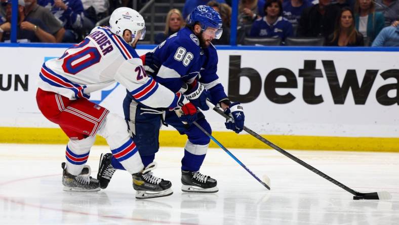 Jun 7, 2022; Tampa, Florida, USA; Tampa Bay Lightning right wing Nikita Kucherov (86) controls the puck  against New York Rangers left wing Chris Kreider (20) in the third period in game four of the Eastern Conference Final of the 2022 Stanley Cup Playoffs at Amalie Arena. Mandatory Credit: Nathan Ray Seebeck-USA TODAY Sports