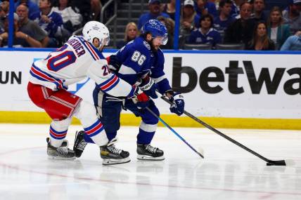 Jun 7, 2022; Tampa, Florida, USA; Tampa Bay Lightning right wing Nikita Kucherov (86) controls the puck  against New York Rangers left wing Chris Kreider (20) in the third period in game four of the Eastern Conference Final of the 2022 Stanley Cup Playoffs at Amalie Arena. Mandatory Credit: Nathan Ray Seebeck-USA TODAY Sports