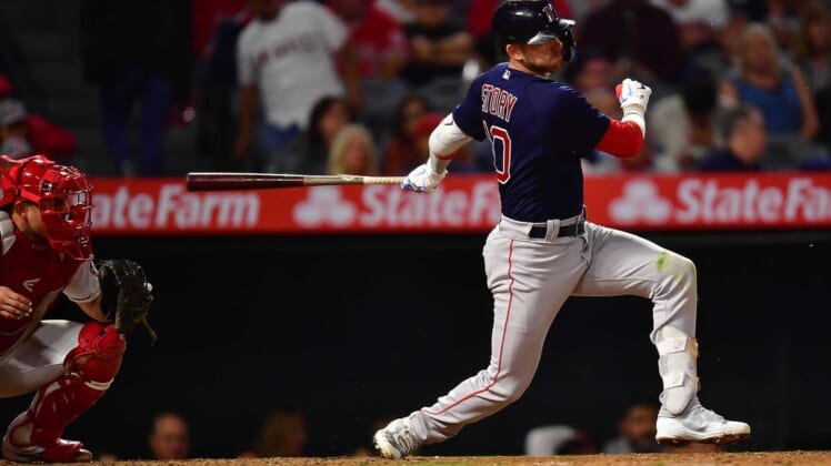 Jun 7, 2022; Anaheim, California, USA; Boston Red Sox second baseman Trevor Story (10) hits an RBI single against the Los Angeles Angels during the seventh inning at Angel Stadium. Mandatory Credit: Gary A. Vasquez-USA TODAY Sports