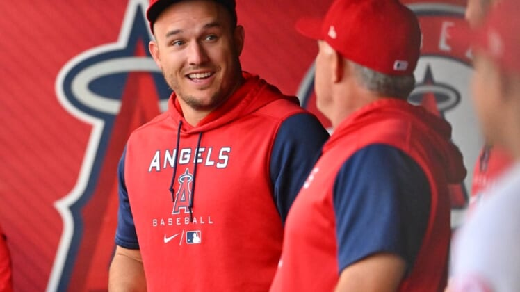 Jun 8, 2022; Anaheim, California, USA;  Los Angeles Angels center fielder Mike Trout (27) talks with interim manager Phil Nevin (88) in the dugout during the Boston Red Sox at Angel Stadium. Mandatory Credit: Jayne Kamin-Oncea-USA TODAY Sports