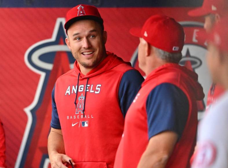 Jun 8, 2022; Anaheim, California, USA;  Los Angeles Angels center fielder Mike Trout (27) talks with interim manager Phil Nevin (88) in the dugout during the Boston Red Sox at Angel Stadium. Mandatory Credit: Jayne Kamin-Oncea-USA TODAY Sports