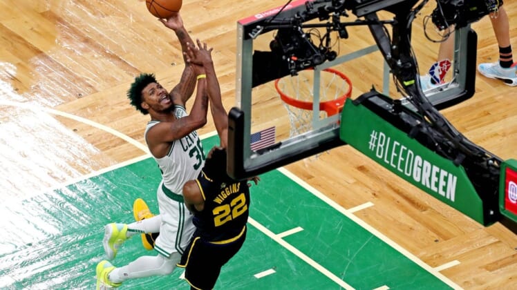 Jun 8, 2022; Boston, Massachusetts, USA; Boston Celtics guard Marcus Smart (36) shoots the ball against Golden State Warriors forward Andrew Wiggins (22) in game three of the 2022 NBA Finals at TD Garden. Mandatory Credit: Paul Rutherford-USA TODAY Sports