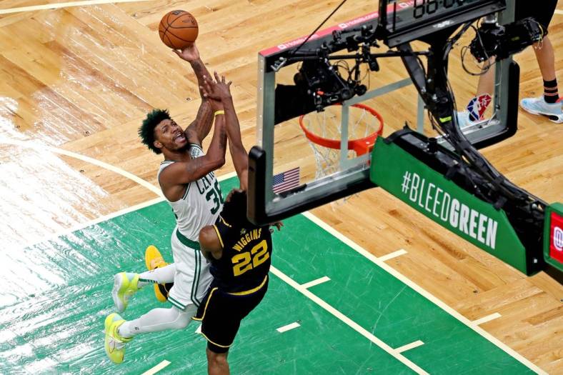 Jun 8, 2022; Boston, Massachusetts, USA; Boston Celtics guard Marcus Smart (36) shoots the ball against Golden State Warriors forward Andrew Wiggins (22) in game three of the 2022 NBA Finals at TD Garden. Mandatory Credit: Paul Rutherford-USA TODAY Sports