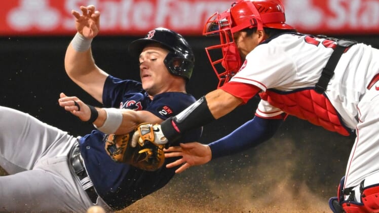 Jun 8, 2022; Anaheim, California, USA;  Boston Red Sox first baseman Bobby Dalbec (29) is tagged out at home by Los Angeles Angels catcher Kurt Suzuki (24) on a throw by shortstop Tyler Wade (14) in the sixth inning at Angel Stadium. Mandatory Credit: Jayne Kamin-Oncea-USA TODAY Sports