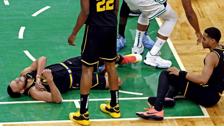 Jun 8, 2022; Boston, Massachusetts, USA; Golden State Warriors guard Stephen Curry (30) reacts to an apparent injury during the fourth quarter against the Boston Celtics in game three of the 2022 NBA Finals at TD Garden. Mandatory Credit: Winslow Townson-USA TODAY Sports