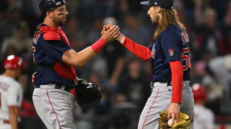 Jun 8, 2022; Anaheim, California, USA;  Boston Red Sox relief pitcher Matt Strahm (55) shakes hands with catcher Kevin Plawecki (25) after the final out the ninth inning earning a save to defeat the Los Angeles Angels for their 14th loss in a row at Angel Stadium. Mandatory Credit: Jayne Kamin-Oncea-USA TODAY Sports