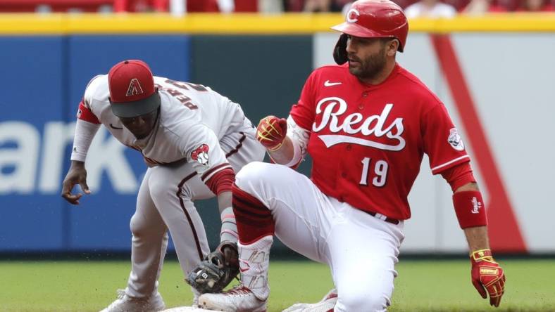 Jun 9, 2022; Cincinnati, Ohio, USA; Cincinnati Reds designated hitter Joey Votto (19) slides into second base against Arizona Diamondbacks shortstop Geraldo Perdomo (2) after hitting a two-run double in the first inning at Great American Ball Park. Mandatory Credit: David Kohl-USA TODAY Sports