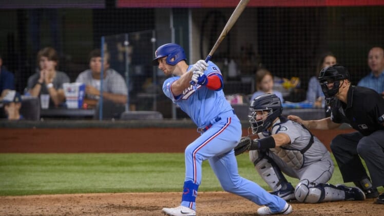Jun 5, 2022; Arlington, Texas, USA; Texas Rangers designated hitter Mitch Garver (18) in action during the game between the Texas Rangers and the Seattle Mariners at Globe Life Field. Mandatory Credit: Jerome Miron-USA TODAY Sports