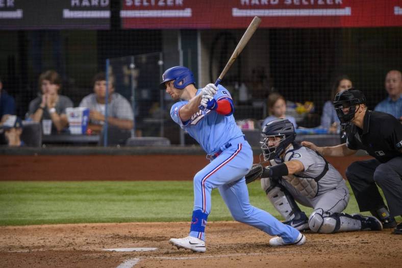 Jun 5, 2022; Arlington, Texas, USA; Texas Rangers designated hitter Mitch Garver (18) in action during the game between the Texas Rangers and the Seattle Mariners at Globe Life Field. Mandatory Credit: Jerome Miron-USA TODAY Sports