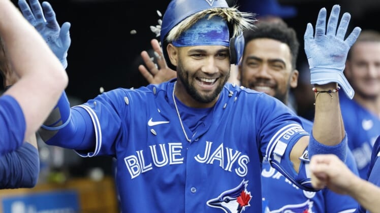 Jun 10, 2022; Detroit, Michigan, USA;  Toronto Blue Jays left fielder Lourdes Gurriel Jr. (13) receives congratulations from teammates after he hits a home run in the second inning against the Detroit Tigers at Comerica Park. Mandatory Credit: Rick Osentoski-USA TODAY Sports