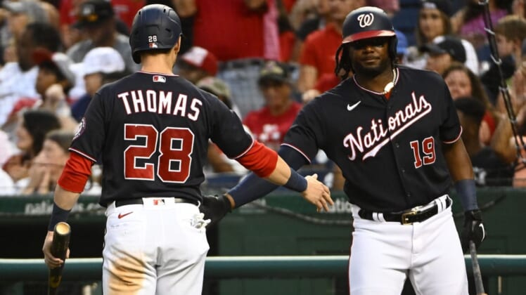 Jun 10, 2022; Washington, District of Columbia, USA; Washington Nationals left fielder Lane Thomas (28) is congratulated by first baseman Josh Bell (19) after scoring a run against the Milwaukee Brewers during the third inning at Nationals Park. Mandatory Credit: Brad Mills-USA TODAY Sports