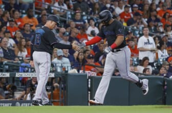 Jun 10, 2022; Houston, Texas, USA; Miami Marlins designated hitter Jesus Aguilar (99) celebrates with major league third base coach Al Pedrique (13) after hitting a home run during the first inning against the Houston Astros at Minute Maid Park. Mandatory Credit: Troy Taormina-USA TODAY Sports