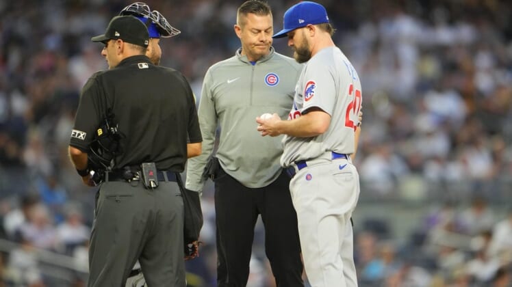 Jun 10, 2022; Bronx, New York, USA; The Chicago Cubs trainer P.J. Mainville attends to pitcher Wade Miley (20) during the fourth inning against the New York Yankees at Yankee Stadium. Mandatory Credit: Gregory Fisher-USA TODAY Sports