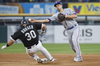 Jun 10, 2022; Chicago, Illinois, USA; Texas Rangers shortstop Corey Seager (5) throws to first base after forcing out Chicago White Sox third baseman Jake Burger (30) at second base during the fourth inning at Guaranteed Rate Field. Mandatory Credit: Kamil Krzaczynski-USA TODAY Sports
