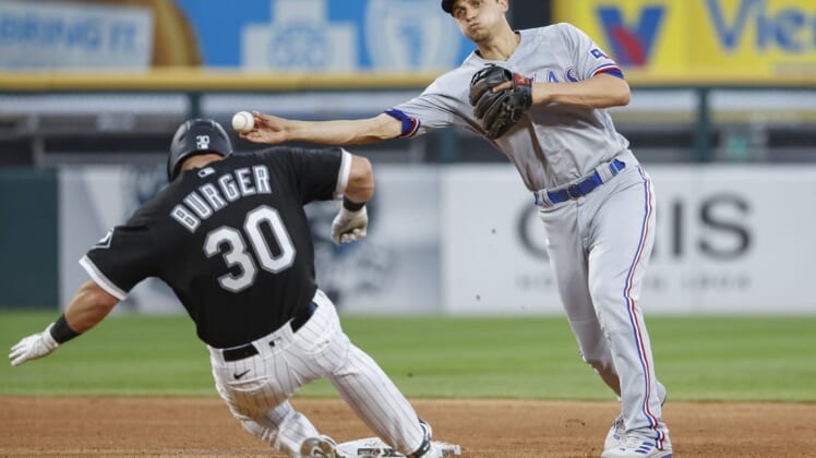 Jun 10, 2022; Chicago, Illinois, USA; Texas Rangers shortstop Corey Seager (5) throws to first base after forcing out Chicago White Sox third baseman Jake Burger (30) at second base during the fourth inning at Guaranteed Rate Field. Mandatory Credit: Kamil Krzaczynski-USA TODAY Sports