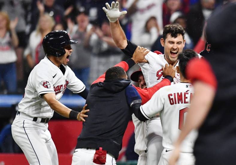 Jun 10, 2022; Cleveland, Ohio, USA; Cleveland Guardians catcher Luke Maile (12) celebrates after hitting a sacrifice fly during the ninth inning to plate the wining run against the Oakland Athletics at Progressive Field. Mandatory Credit: Ken Blaze-USA TODAY Sports