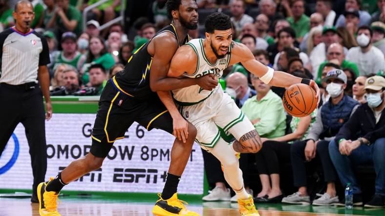 Jun 10, 2022; Boston, Massachusetts, USA; Boston Celtics forward Jayson Tatum (0) dribbles the ball against Golden State Warriors forward Andrew Wiggins (22) during the third quarter of game four in the 2022 NBA Finals at the TD Garden. Mandatory Credit: David Butler II-USA TODAY Sports