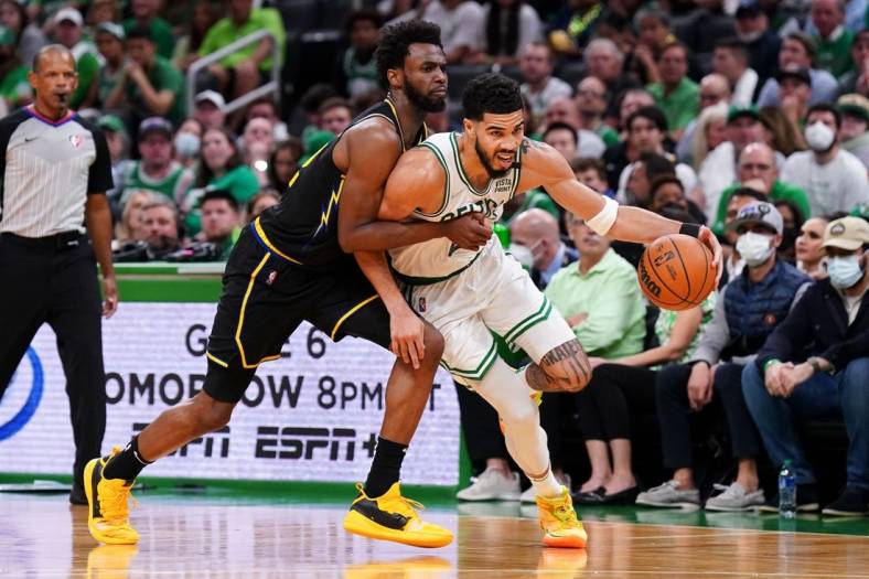 Jun 10, 2022; Boston, Massachusetts, USA; Boston Celtics forward Jayson Tatum (0) dribbles the ball against Golden State Warriors forward Andrew Wiggins (22) during the third quarter of game four in the 2022 NBA Finals at the TD Garden. Mandatory Credit: David Butler II-USA TODAY Sports