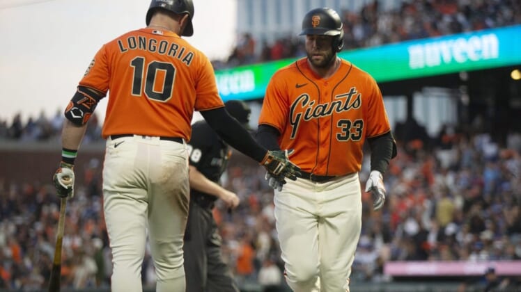 Jun 10, 2022; San Francisco, California, USA; San Francisco Giants first baseman Darin Ruf (33) gets a congratulatory handshake from Evan Longoria (10) after hitting a solo home run off Los Angeles Dodgers starting pitcher Walker Buehler (not pictured) during the fourth inning at Oracle Park. Mandatory Credit: D. Ross Cameron-USA TODAY Sports