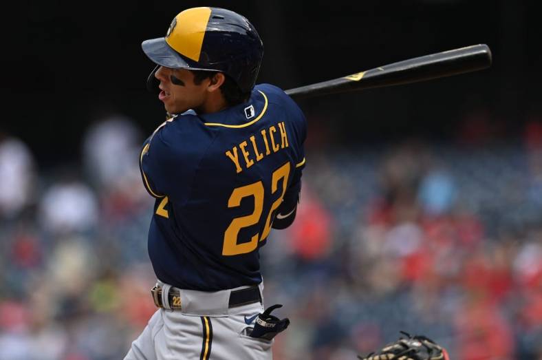 Jun 11, 2022; Washington, District of Columbia, USA;  Milwaukee Brewers left fielder Christian Yelich (22) hits a solo home run against the Washington Nationals during the first inning at Nationals Park. Mandatory Credit: Tommy Gilligan-USA TODAY Sports