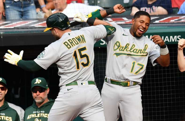 Jun 11, 2022; Cleveland, Ohio, USA; Oakland Athletics left fielder Seth Brown (15) and shortstop Elvis Andrus (17) celebrate after Brown hit a grand slam during the seventh inning against the Cleveland Guardians at Progressive Field. Mandatory Credit: Ken Blaze-USA TODAY Sports