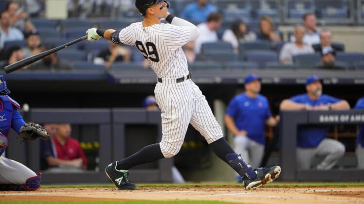 Jun 11, 2022; Bronx, New York, USA; New York Yankees designated hitter Aaron Judge (99) hits a home run against the Chicago Cubs during the first inning at Yankee Stadium. Mandatory Credit: Gregory Fisher-USA TODAY Sports