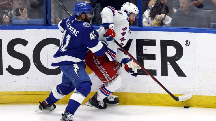 Jun 11, 2022; Tampa, Florida, USA; New York Rangers center Kevin Rooney (17) skates with the puck against Tampa Bay Lightning left wing Pierre-Edouard Bellemare (41) during the second period of game six of the Eastern Conference Final of the 2022 Stanley Cup Playoffs at Amalie Arena. Mandatory Credit: Kim Klement-USA TODAY Sports