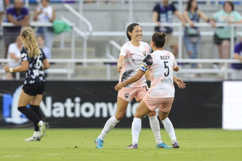 Jun 11, 2022; Louisville, Kentucky, USA;  Angel City FC defender Ali Riley (5) celebrates a goal made by Angel City FC forward Christen Press (23) against Racing Louisville FC during the second half at Lynn Family Stadium. Mandatory Credit: Aaron Doster-USA TODAY Sports