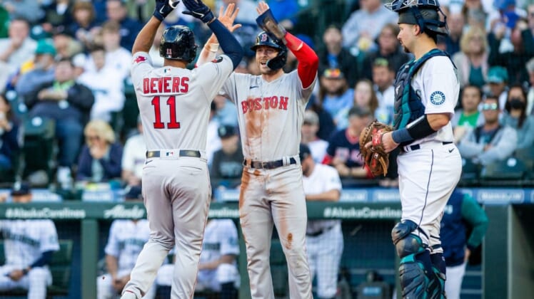 Jun 11, 2022; Seattle, Washington, USA;  Boston Red Sox third baseman Rafael Devers (11) is greeted by second baseman Trevor Story (10) after a two run home run by Devers against the Seattle Mariners during the first inning at T-Mobile Park. Mandatory Credit: Lindsey Wasson-USA TODAY Sports