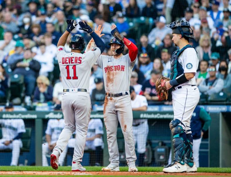 Jun 11, 2022; Seattle, Washington, USA;  Boston Red Sox third baseman Rafael Devers (11) is greeted by second baseman Trevor Story (10) after a two run home run by Devers against the Seattle Mariners during the first inning at T-Mobile Park. Mandatory Credit: Lindsey Wasson-USA TODAY Sports