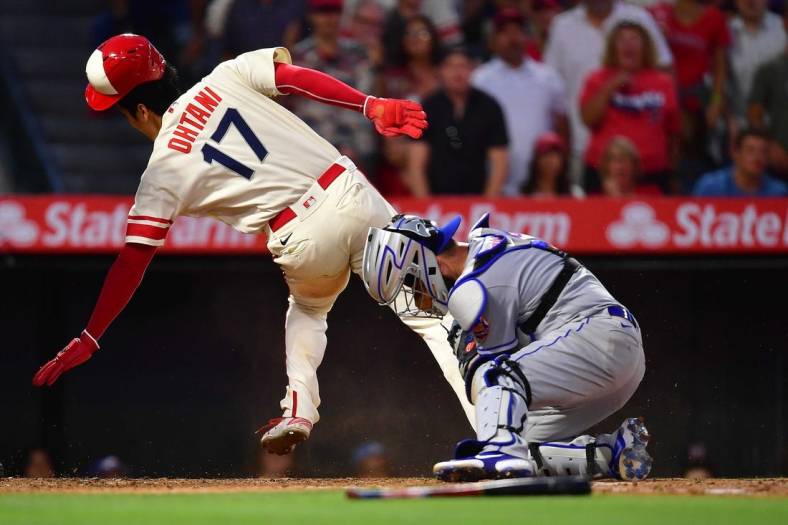 Jun 11, 2022; Anaheim, California, USA; Los Angeles Angels designated hitter Shohei Ohtani (17) is out at home against New York Mets catcher Tomas Nido (3) during the third inning at Angel Stadium. Mandatory Credit: Gary A. Vasquez-USA TODAY Sports