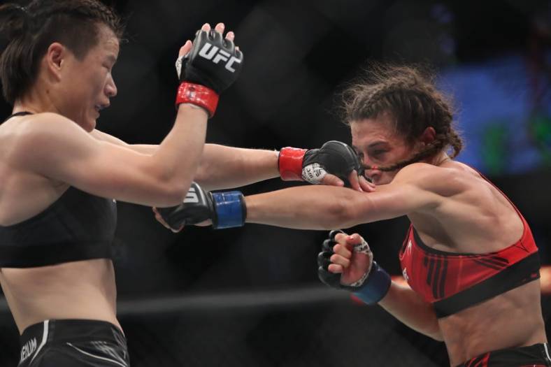 Jun 12, 2022; Singapore, SIN; Zhang Weili (red gloves) fights Joanna Jedrzejczyk (blue gloves) during UFC 275 at Singapore Indoor Stadium. Mandatory Credit: Paul Miller-USA TODAY Sports